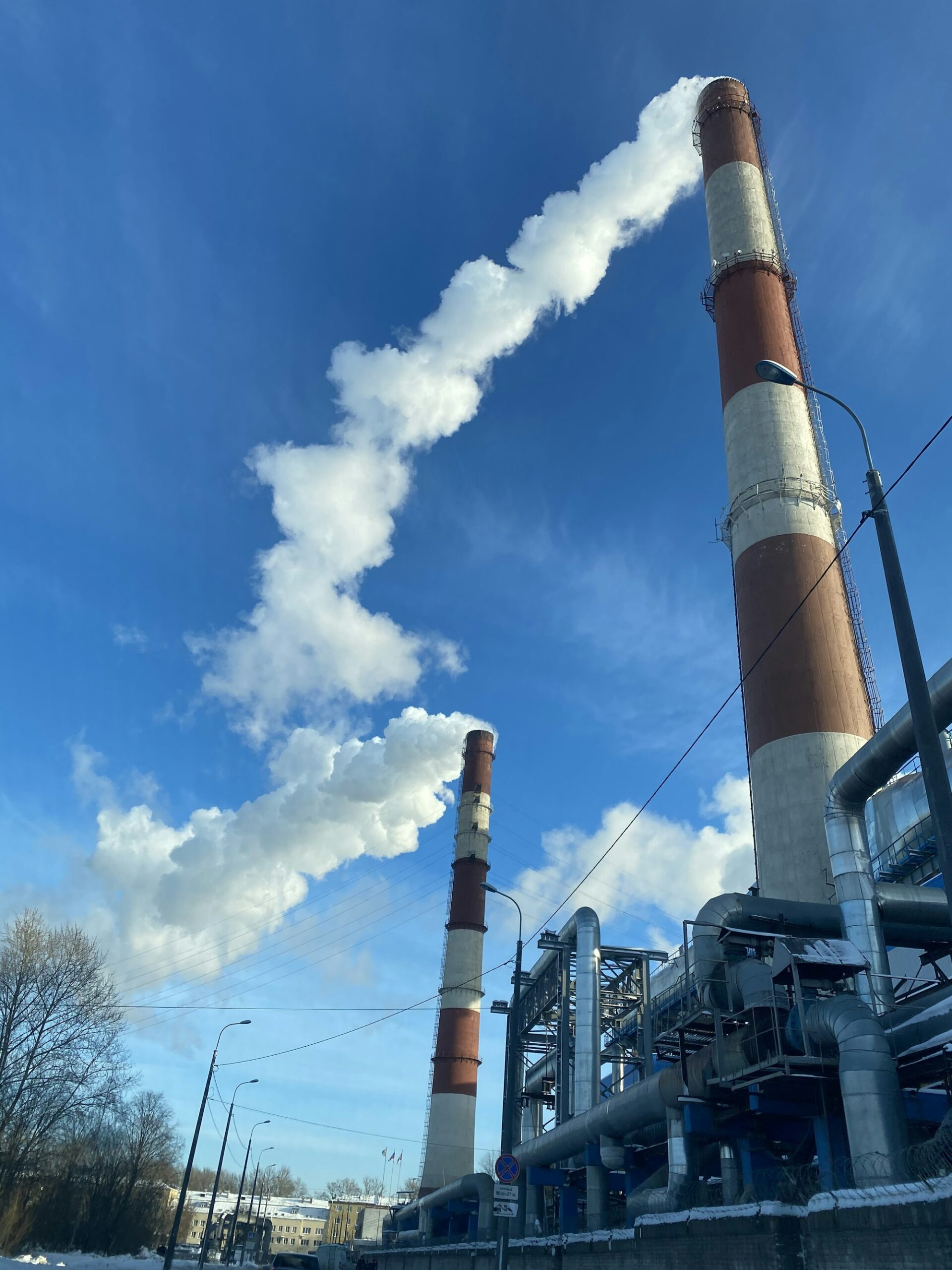 Industrial stacks releasing smoke into the sky, the kind of emissions regulators say an unpermitted generator fleet can produce at full capacity